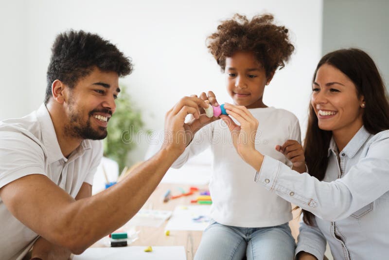 Mother and father drawing together with their child royalty free stock image Mother and father drawing together with their child royalty free stock image