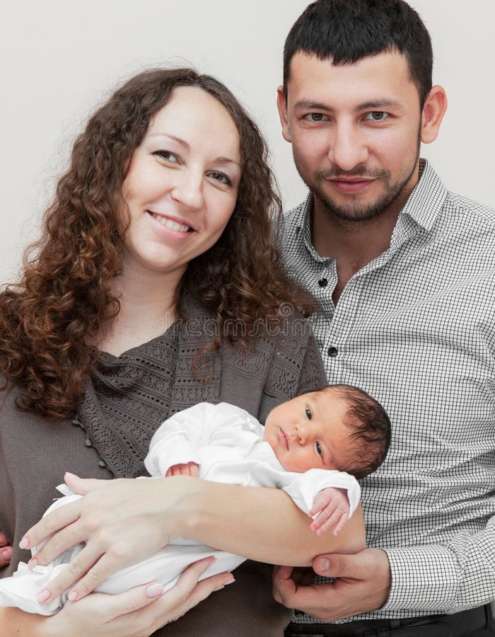 Mother and father holding newborn