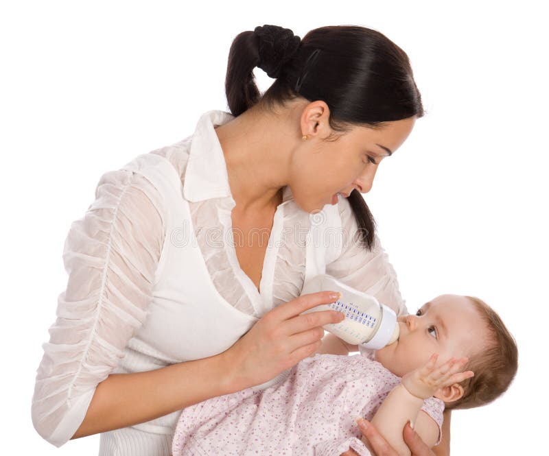 Mother feeding baby daughter stock image