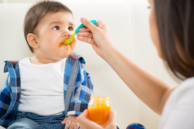 Mother feeding her baby stock image Mother feeding her baby stock image