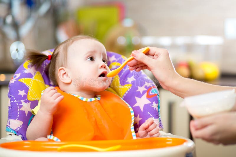 Mother Feeds Funny Baby from a Spoon Stock Photo Image of care, girl