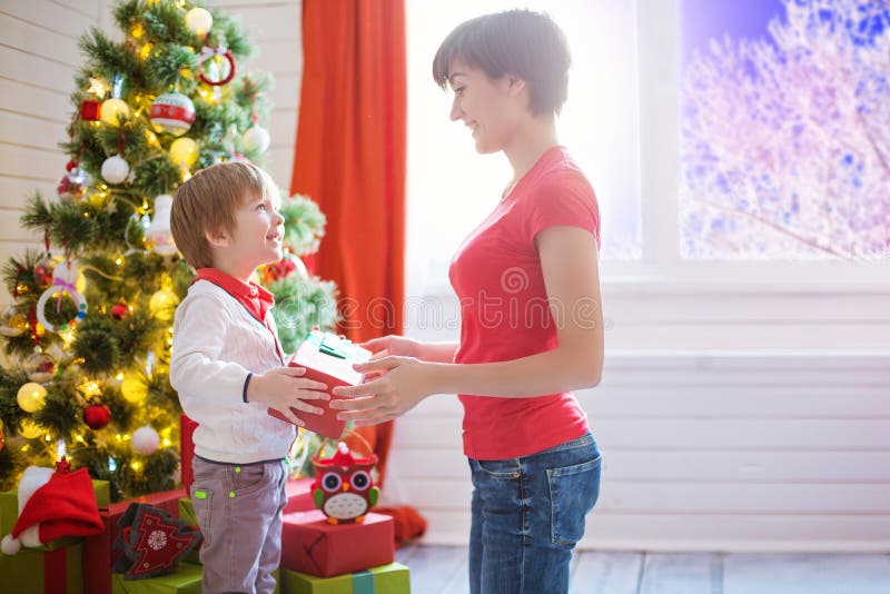 https://thumbs.dreamstime.com/b/mother-gives-gift-to-her-son-christmas-son-gives-gift-to-his-mom-mother-gives-gift-to-her-son-christmas-son-134088894.jpg