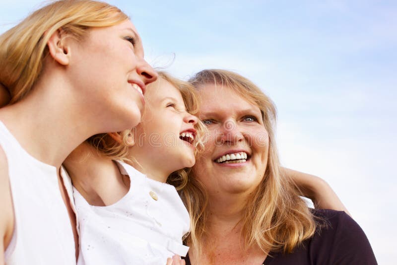 Mother, grandmother and little girl looking up