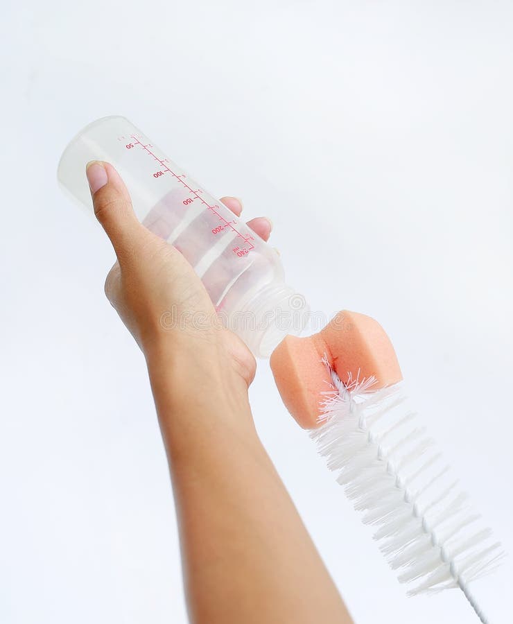 Mother hand washing baby milk bottle by bottle brush on white background royalty free stock photo Mother hand washing baby milk bottle by bottle brush on white background royalty free stock photo