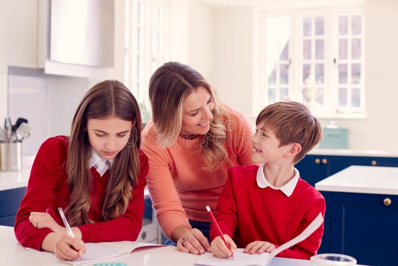 Mother Helping Children in School Uniform Doing Homework at Kitchen