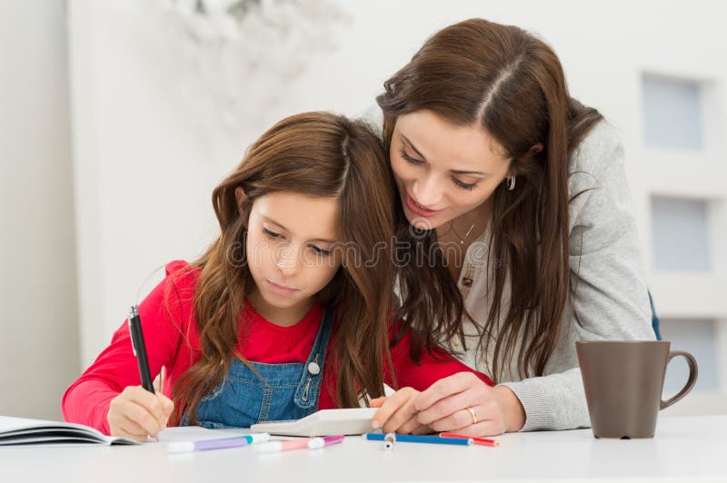 Mother Helping Her Daughter While Studying royalty free stock images Mother Helping Her Daughter While Studying royalty free stock images