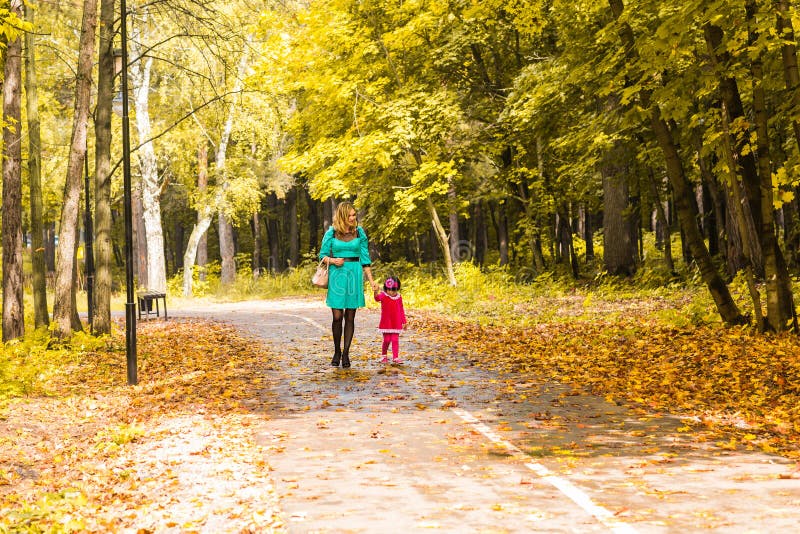 Mother with her baby. Mom and daughter in an autumn park royalty free stock images Mother with her baby. Mom and daughter in an autumn park royalty free stock images