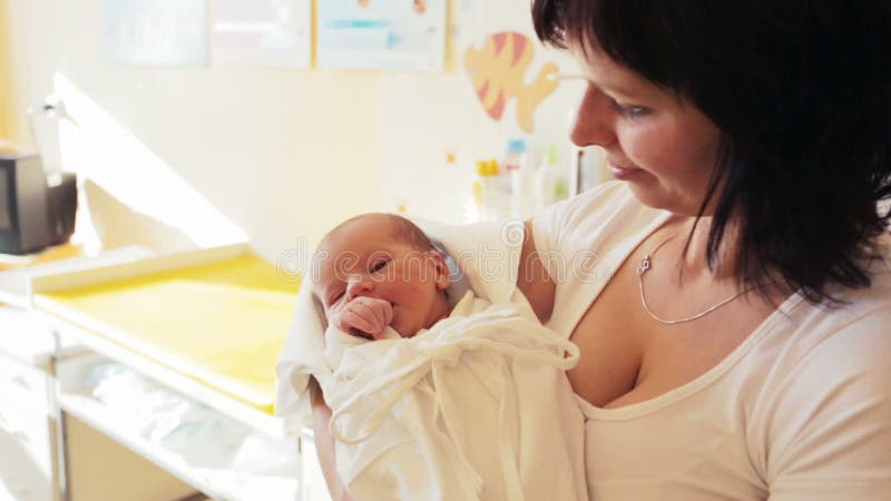 Mother with her cute little baby, first hours of the new life