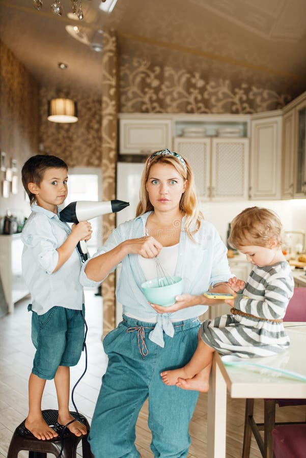 Mother and her kids cooking pastry with chocolate stock photo Mother and her kids cooking pastry with chocolate stock photo