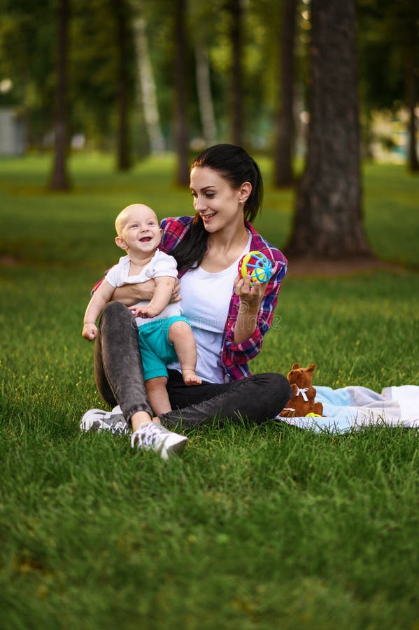 mother her little baby poses grass park summer mom male kid lawn picnic child plaid forest family happiness 198022043