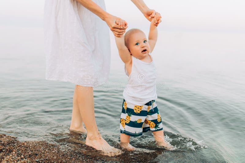 Mother and her son are having fun on the coast, mother and her child are playing