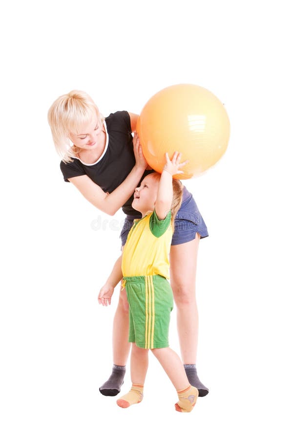 Mother and her son with a fitness ball in their ha