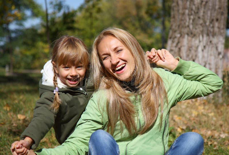 Mother and her toddler girl in autumn fields