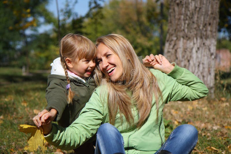 Mother and her toddler girl in autumn fields