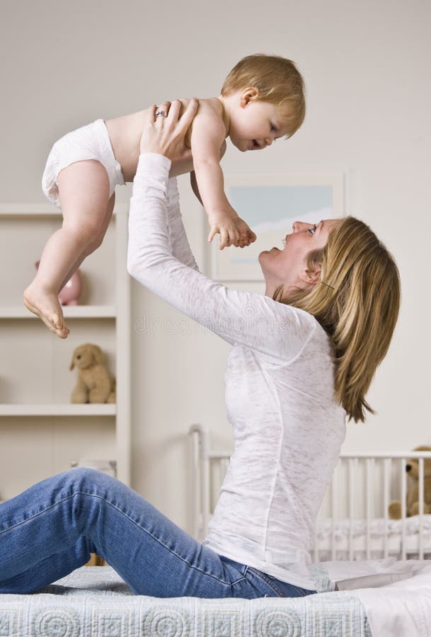 Woman Changing Baby stock image. Image of standing, changing - 10185247