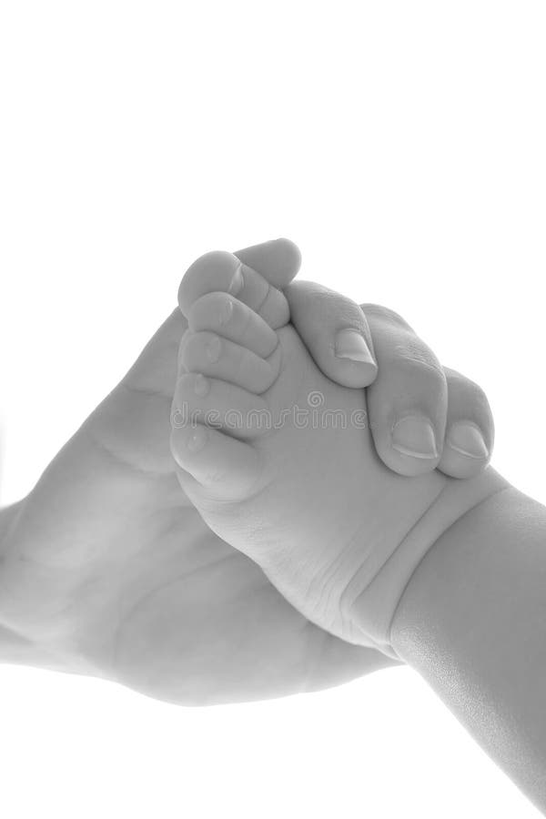 Mother holding babys foot black white