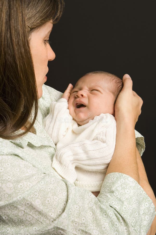 Mother Holding Crying Baby. Stock Photo Image of
