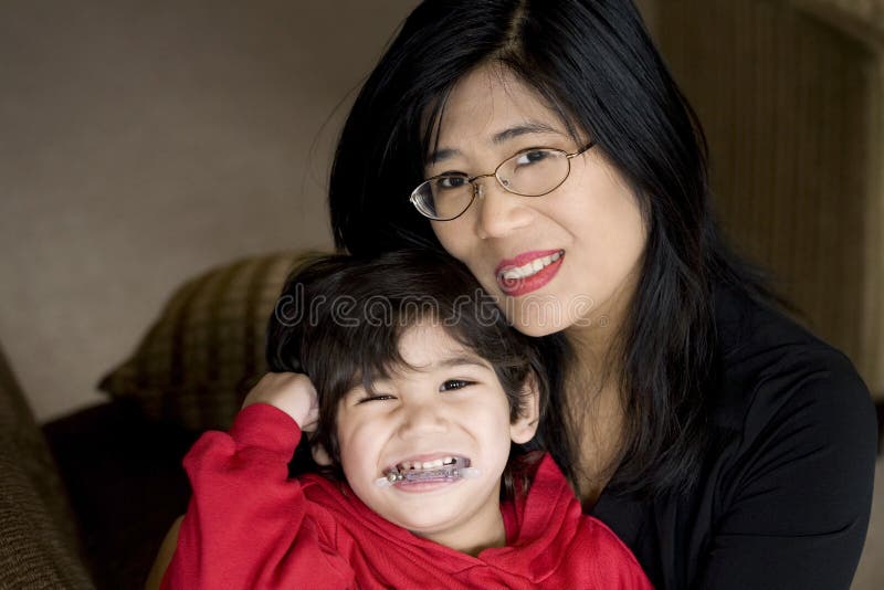 Mother holding disabled son