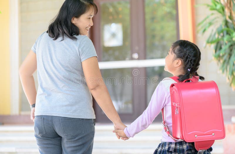 Mother holding hand of daughter going to school, royalty free stock photos Mother holding hand of daughter going to school, royalty free stock photos