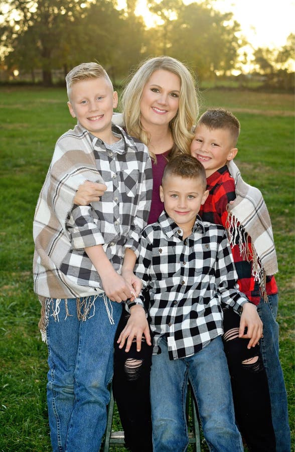 Mother holding her three young boys royalty free stock photography Mother holding her three young boys royalty free stock photography