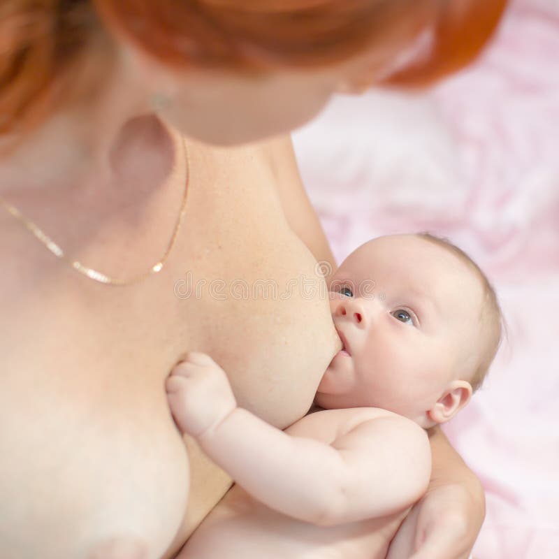 Mother Holding Newborn Baby And Breastfeed Sto