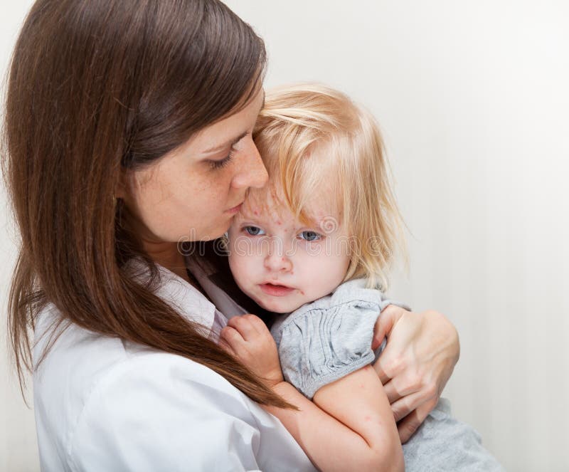 A mother is holding a sick girl. stock images A mother is holding a sick girl. stock images