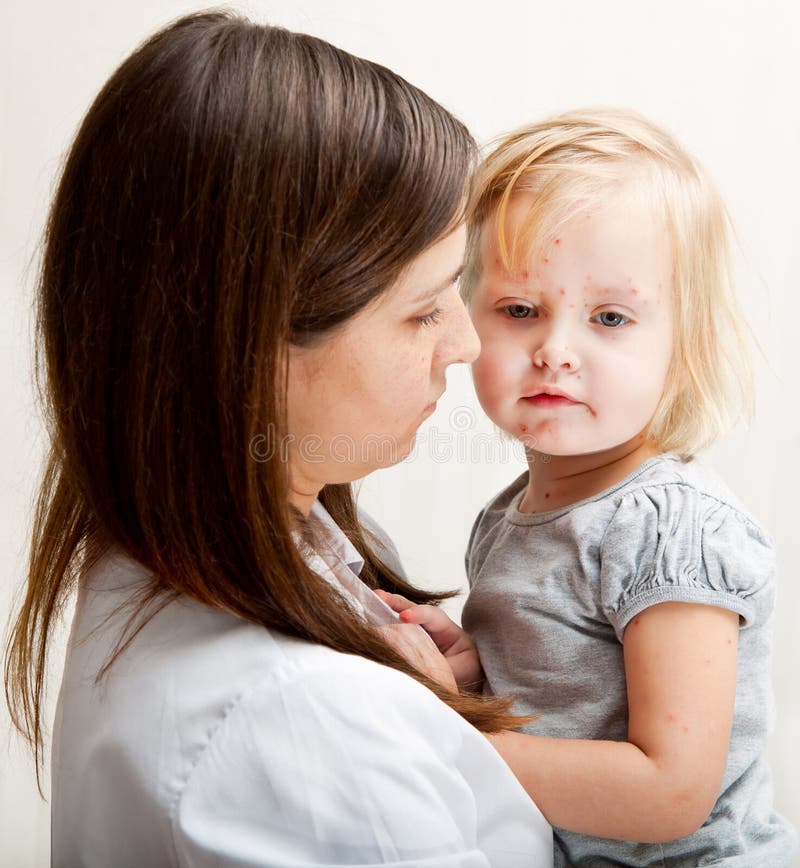 A mother is holding a sick girl. royalty free stock photo A mother is holding a sick girl. royalty free stock photo