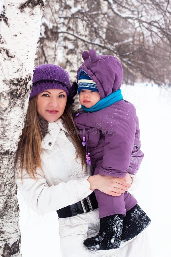 Mother keeps a small child in her arms.