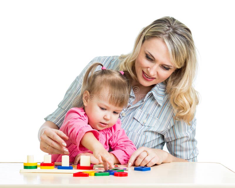 Mother and kid play with colorful puzzle toy stock photos