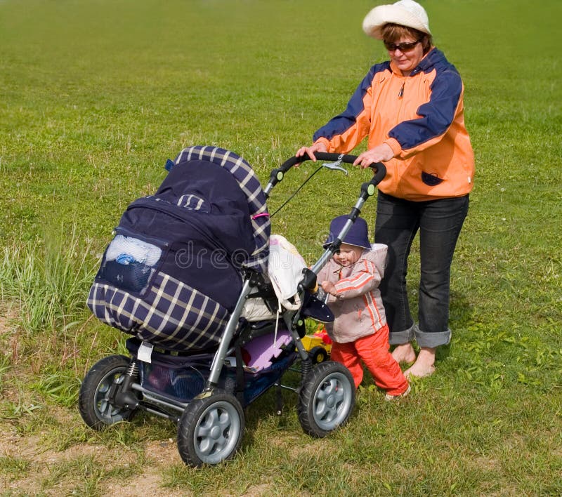 mother and kid with stroller stock photos