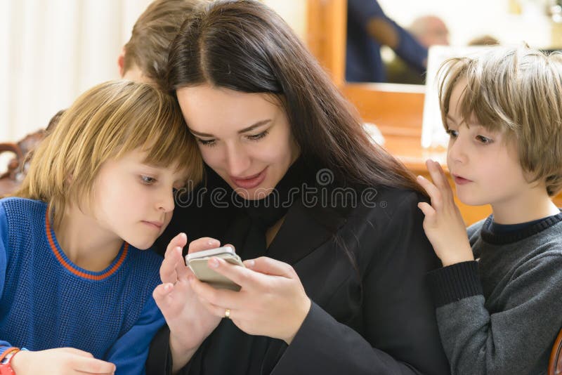Mother and Kids Enjoying Smartphone royalty free stock photos