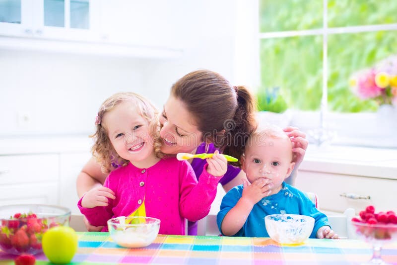 Mother and kids having breakfast