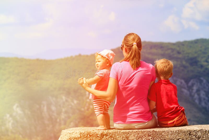 Mother with kids having rest in scenic mountains stock image Mother with kids having rest in scenic mountains stock image