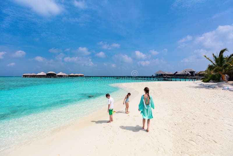 Mother and kids at tropical beach stock photos Mother and kids at tropical beach stock photos