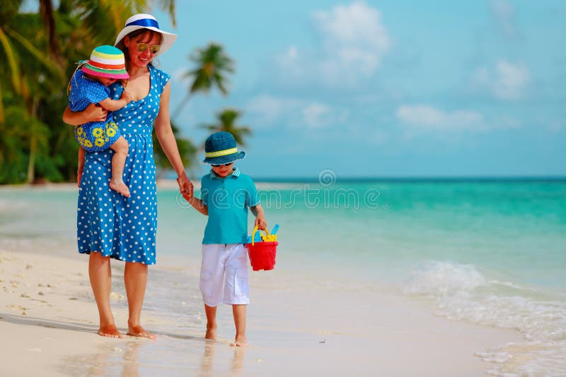 Mother with kids walk on beach, family vacation stock photos Mother with kids walk on beach, family vacation stock photos