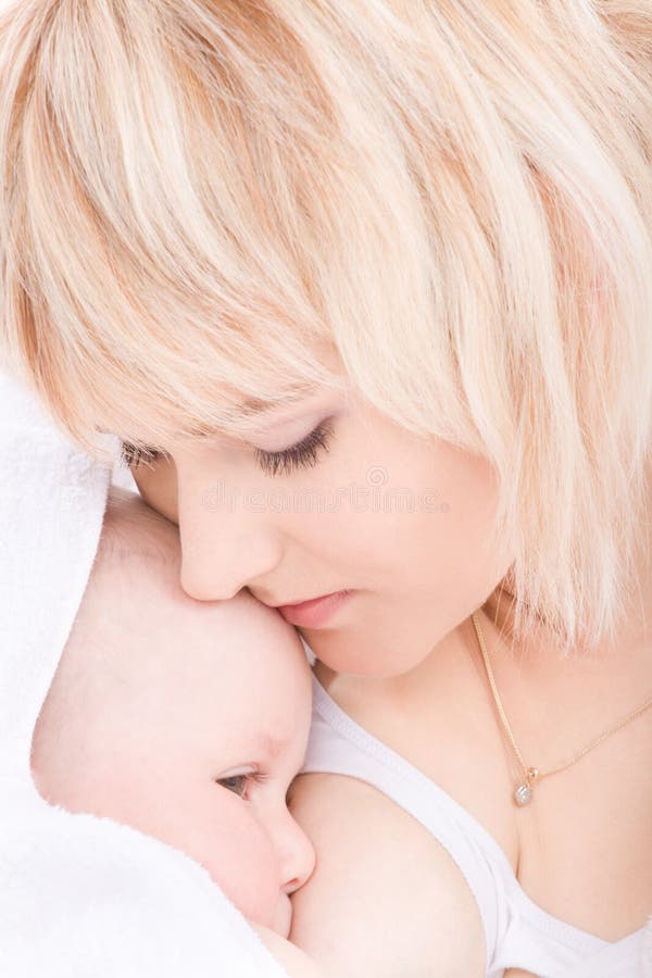 Mother kiss and breast feeding her baby