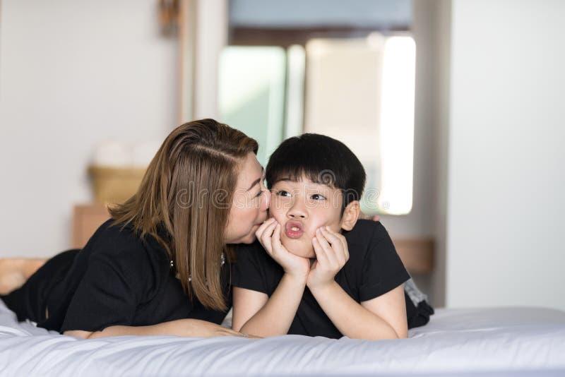 Mother Kiss Her Son In Bedroom Stock Image Image Of Kissing