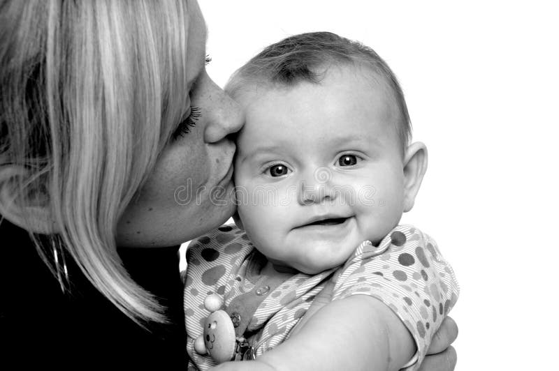 Mother is kissing baby