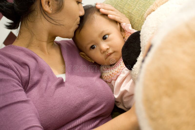 Mother kissing baby