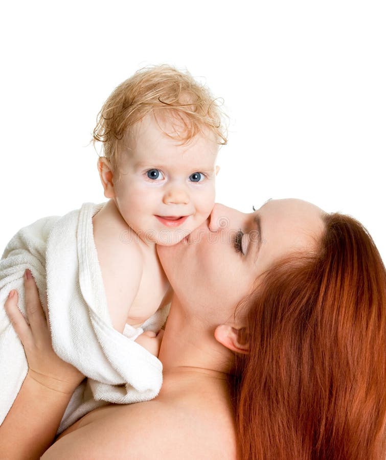 Mother kissing baby girl in a towel after bathing royalty free stock photo Mother kissing baby girl in a towel after bathing royalty free stock photo