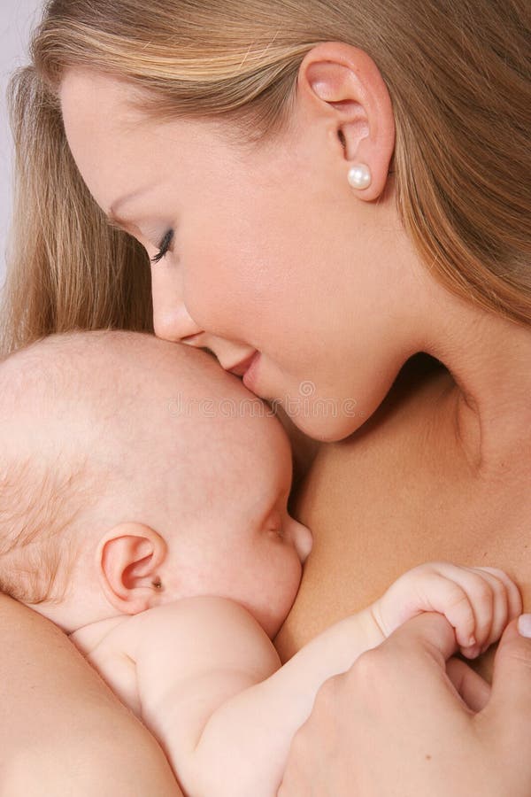 Mother kissing her child