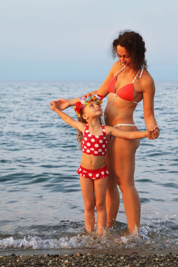 Mother with the daughter on the beach free image download