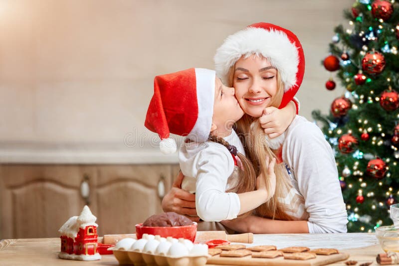 Mother and little girl baking Christmas pastry. Children bake gingerbread. royalty free stock photos Mother and little girl baking Christmas pastry. Children bake gingerbread. royalty free stock photos