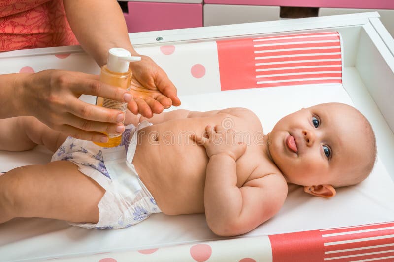 Mother makes massage for her baby and apply oil on the hands royalty free stock photos Mother makes massage for her baby and apply oil on the hands royalty free stock photos