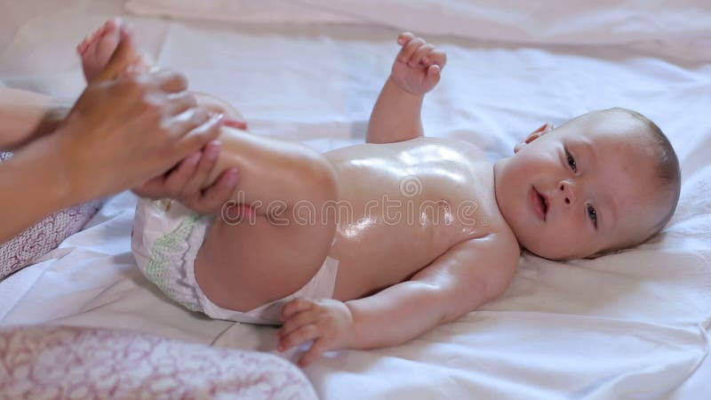 Mother Makes Newborn Baby Massage, Apply Oil on the Body, on White Background. Stock Footage - Video of foot, child: 131088078