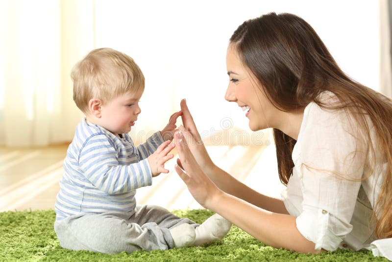 Mother playing with her baby on a carpet