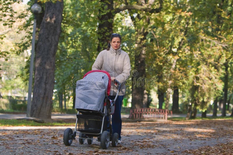 Mother with pram royalty free stock photography
