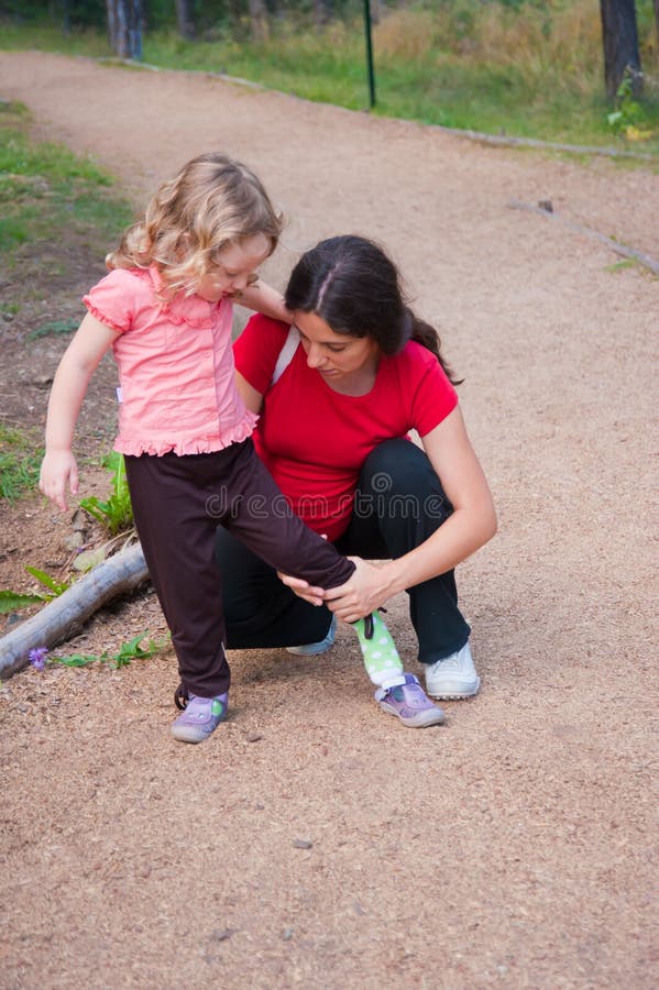 Mother Putting shoe to her child