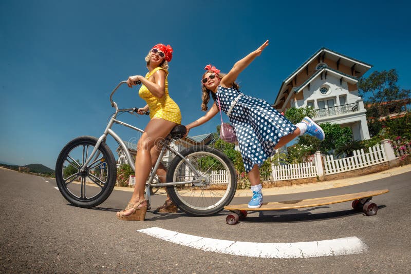 Mother Riding Bike with Her Daughter on Skateboard Stock Photo - Image ...