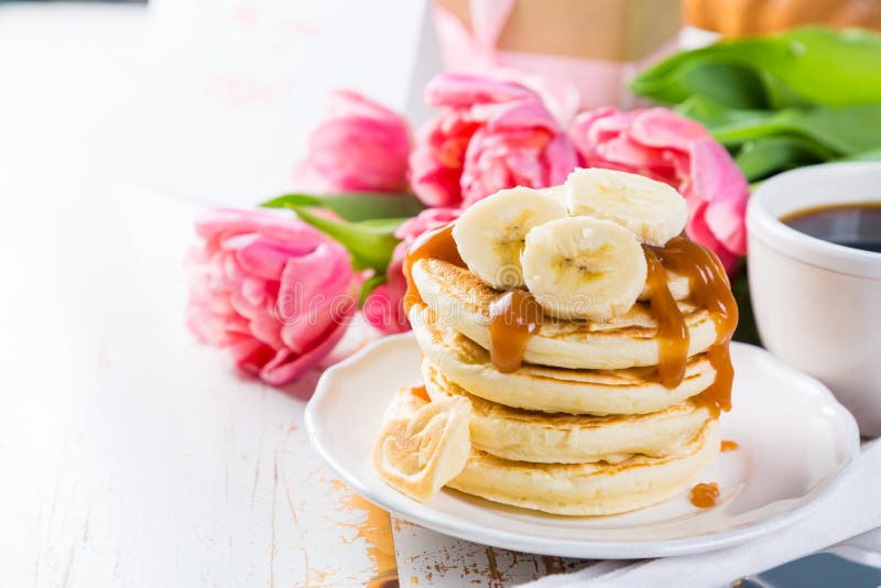 Mother`s Day Breakfast Concept Pancakes, Coffee, Flowers, Present